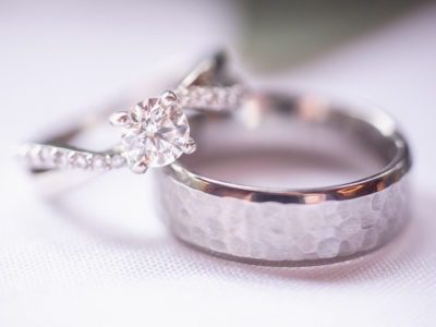 Set of silver engagement rings: one feminine, one masculine