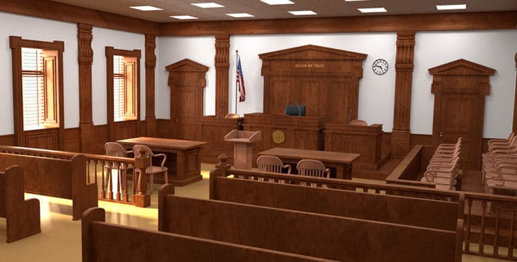 empty courtroom with brown benches and white walls