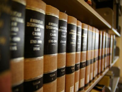 Close up of volumes of law books sitting on a shelf in a library