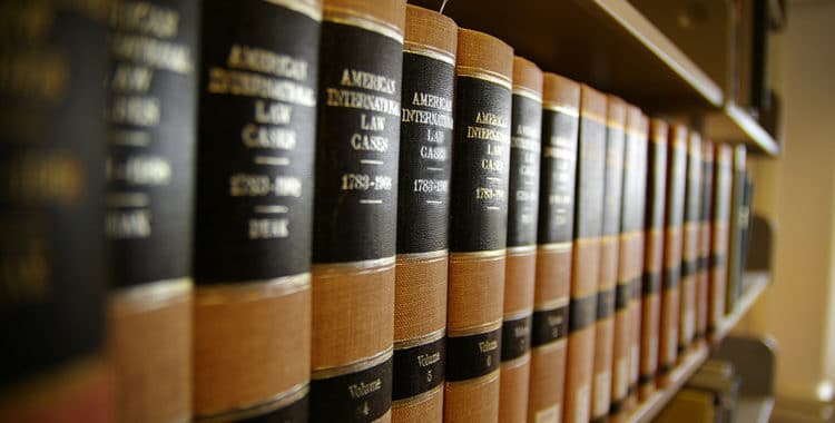 Close up of volumes of law books sitting on a shelf in a library